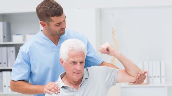 Doctor helping man stretch